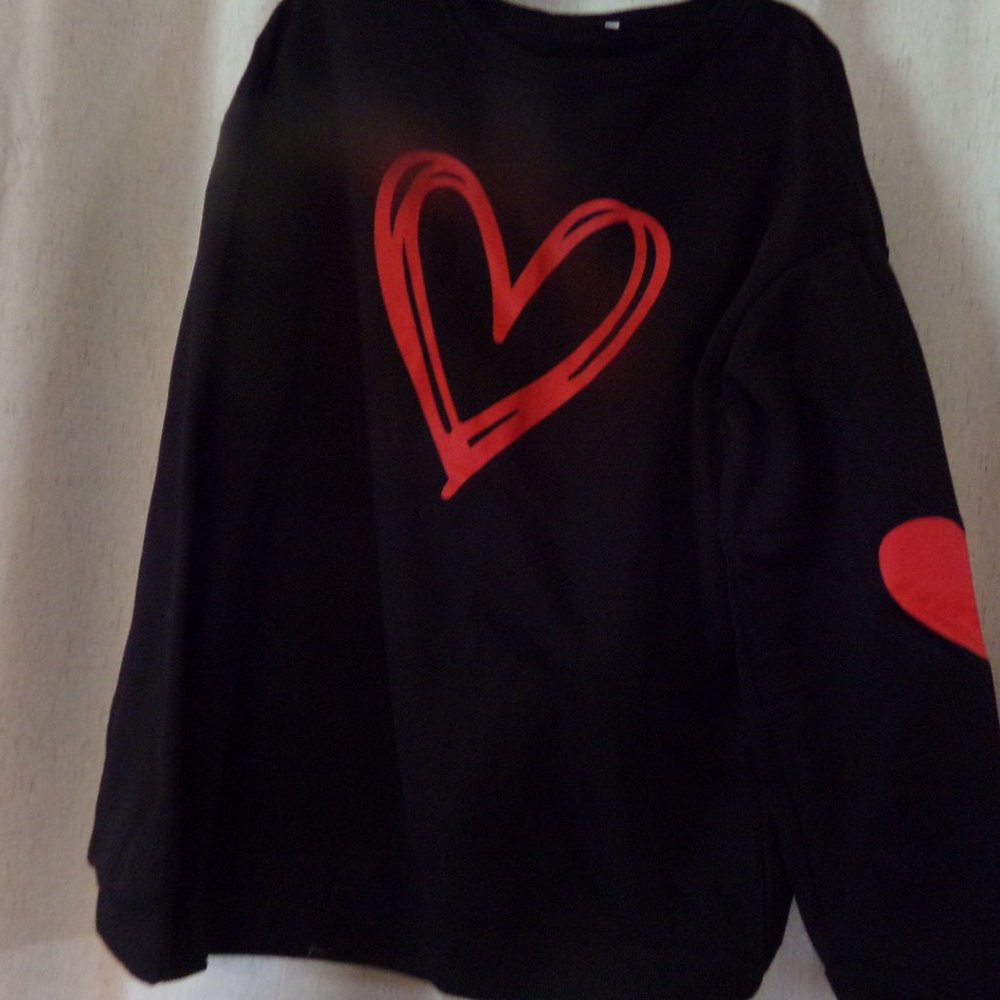 Black sweatshirt with red heart and heart on sleeve
